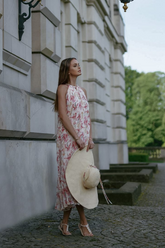 a lady in a pink floral printed off the shoulder dress